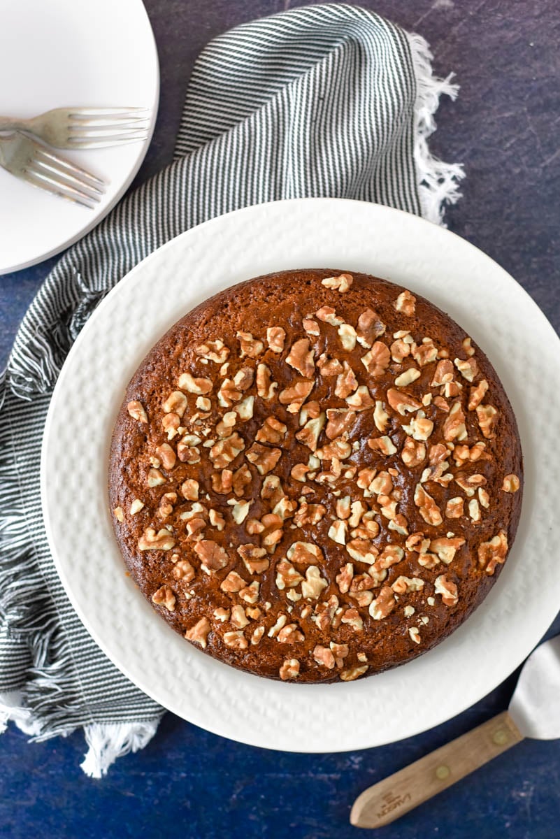 overhead view of armenian nutmeg cake on white platter