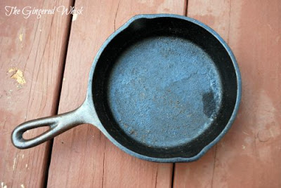 How to Clean Your Cast Iron the Proper Way! (The Gingered Whisk) overhead view of cast iron skillet that needs to be stripped and reseasoned