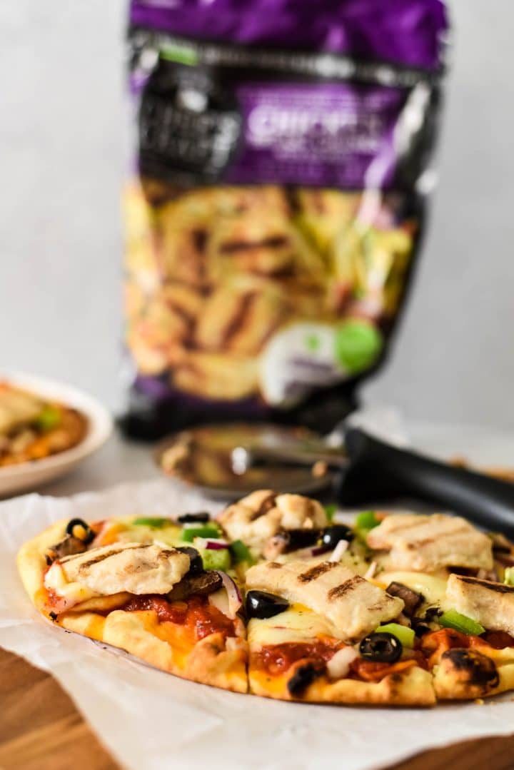 chicken naan pizza with bag of chicken behind