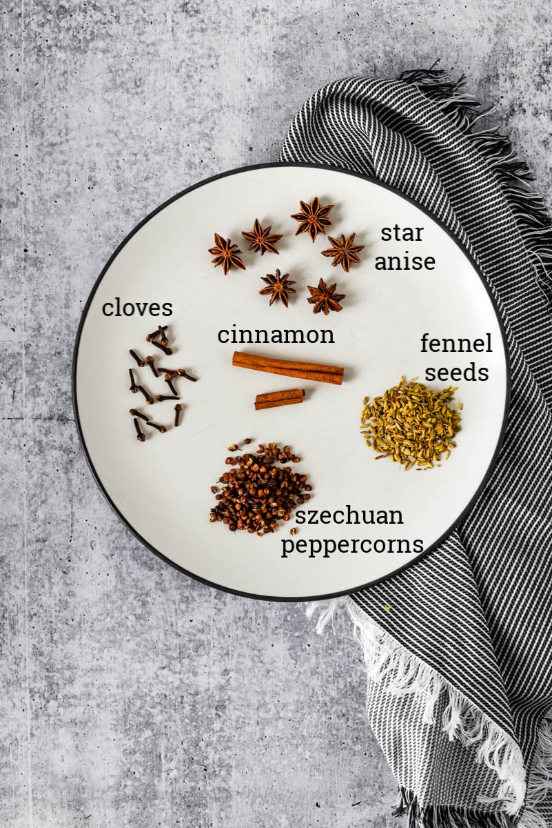 whole spices for Chinese Five Spice on plate with grey napkin