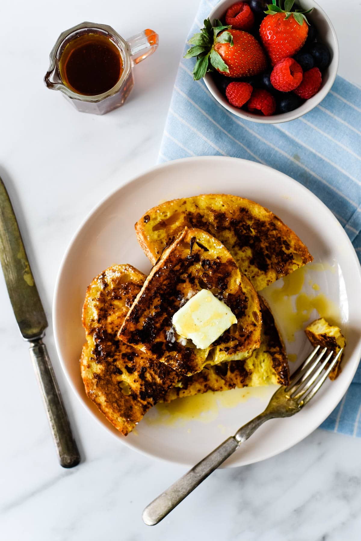 plate with sourdough french toast with fork beside