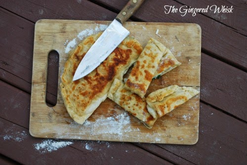gozleme on cutting board with slices and knife