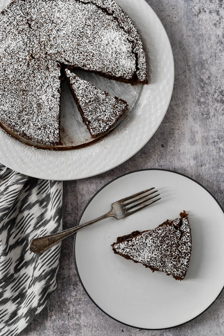 chocolate sticky cake on white plate with fork
