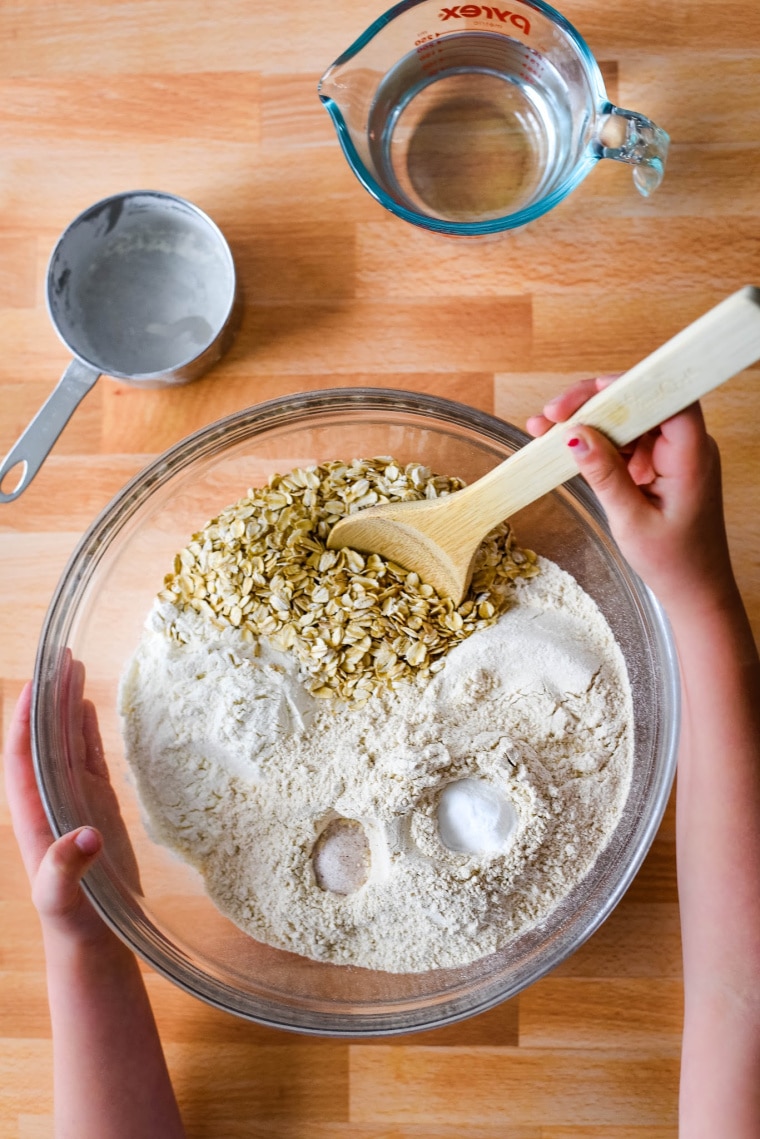 ingredients for viking bread in glass bowl with child hand